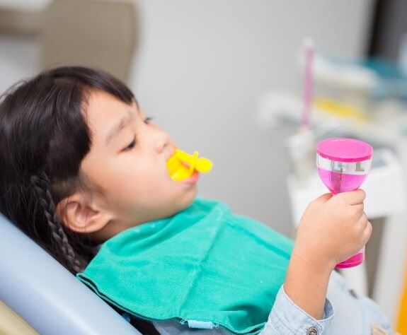 Young dental patient receiving fluoride treatment