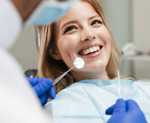 Dentist talking to a happy patient