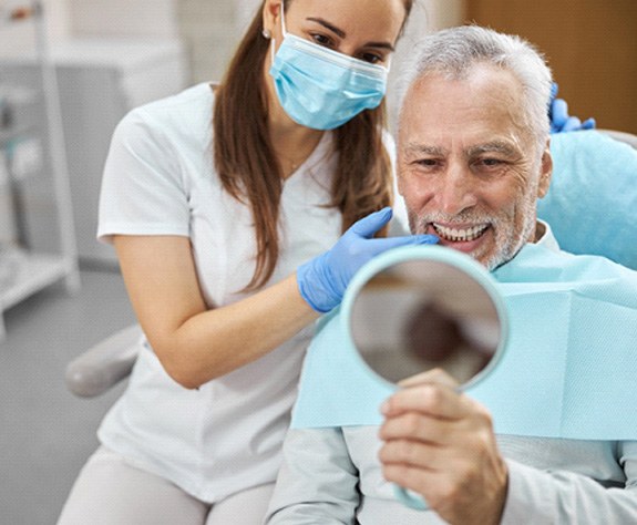 An aging gentleman happy with his new dental implant