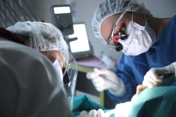 Dentists performing oral surgery