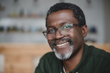 Older man smiling and enjoying his dental implants