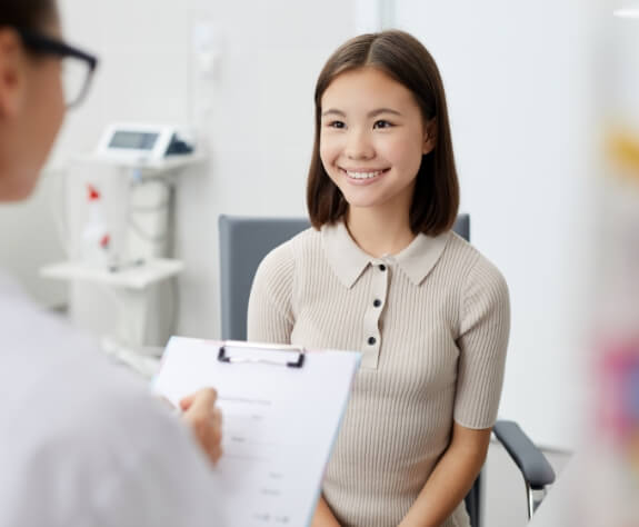 Young woman smiling during emergency dentistry visit