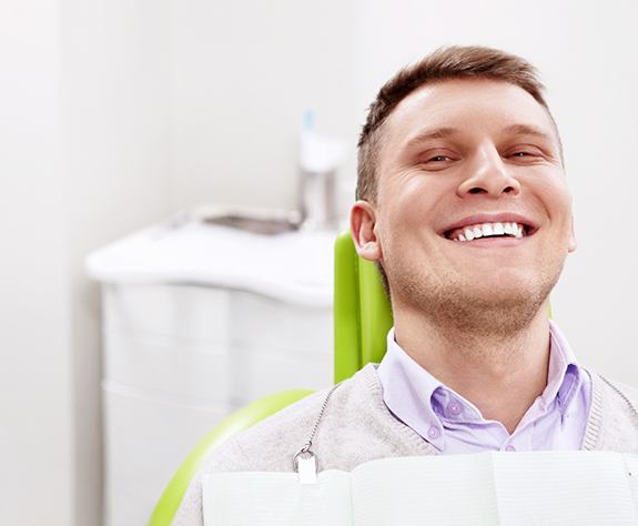 Bearded man pulling up lip to show gum disease in Raleigh, NC