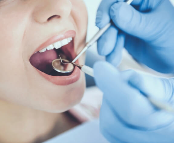 Closeup of dental patient receiving and oral cancer screening