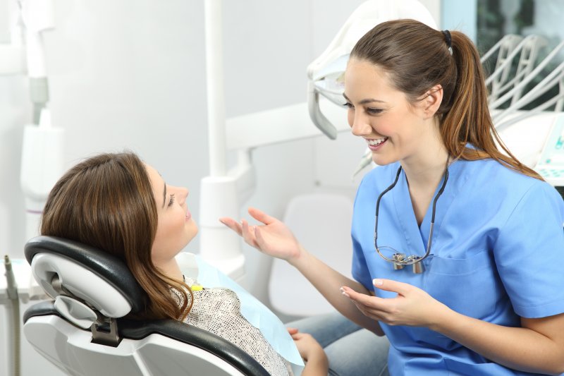 person speaking with cosmetic dentist about gum disease therapy