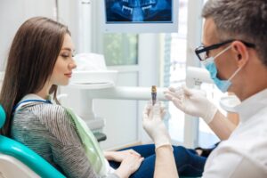 female patient talking to dentist about dental implants 