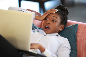 Woman looking at her computer in shock